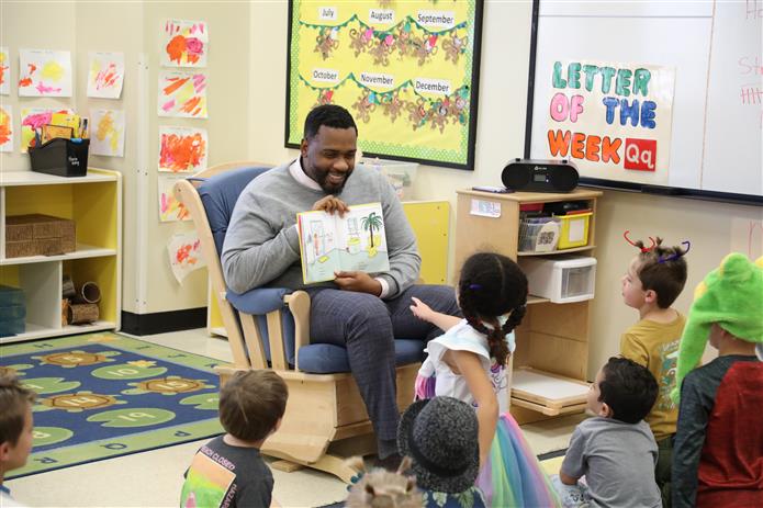 Image of Principal Franklin (Chandler High School) reading to CHS Lil' Explorers